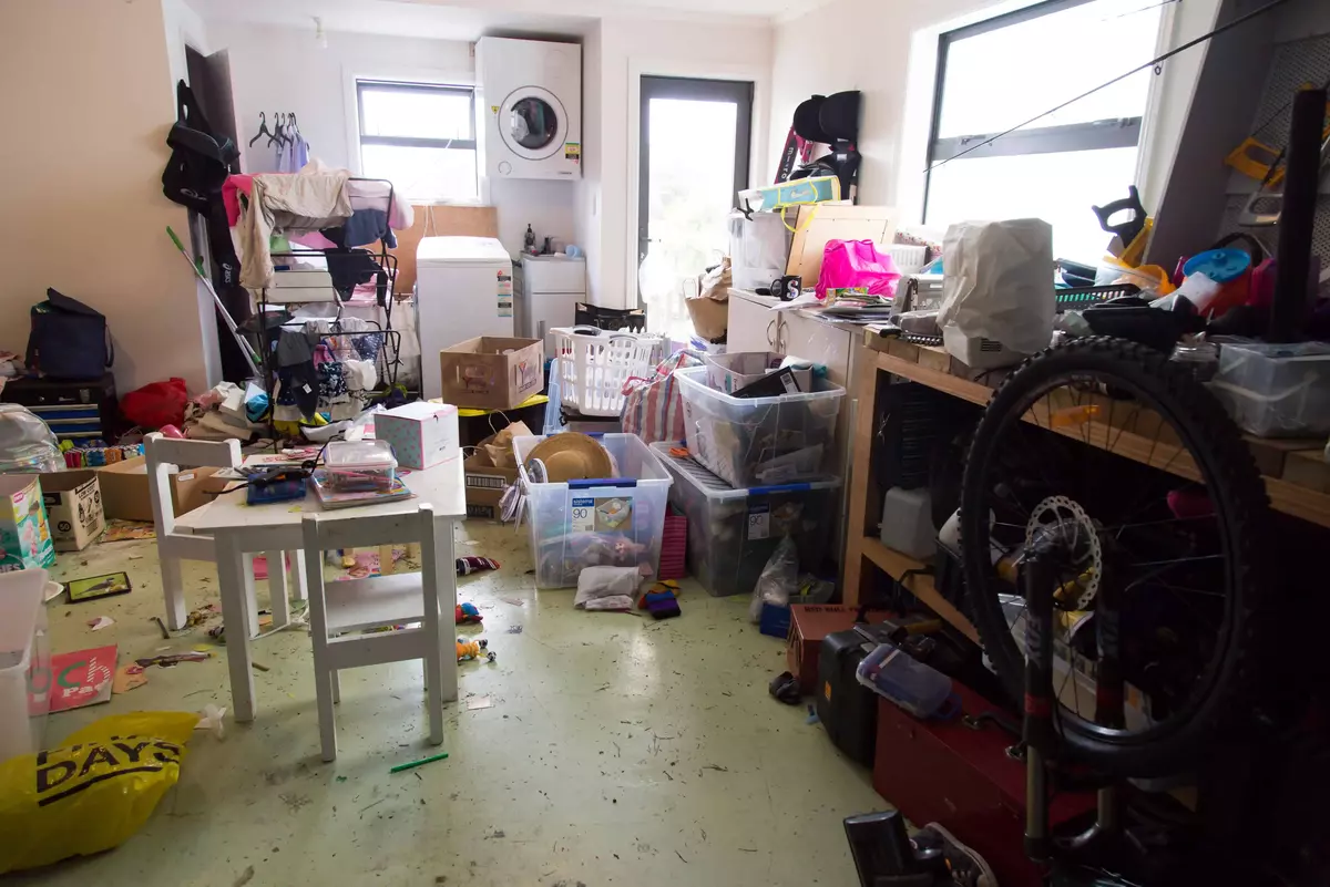 Garage with exercise equipment and plastic tubs