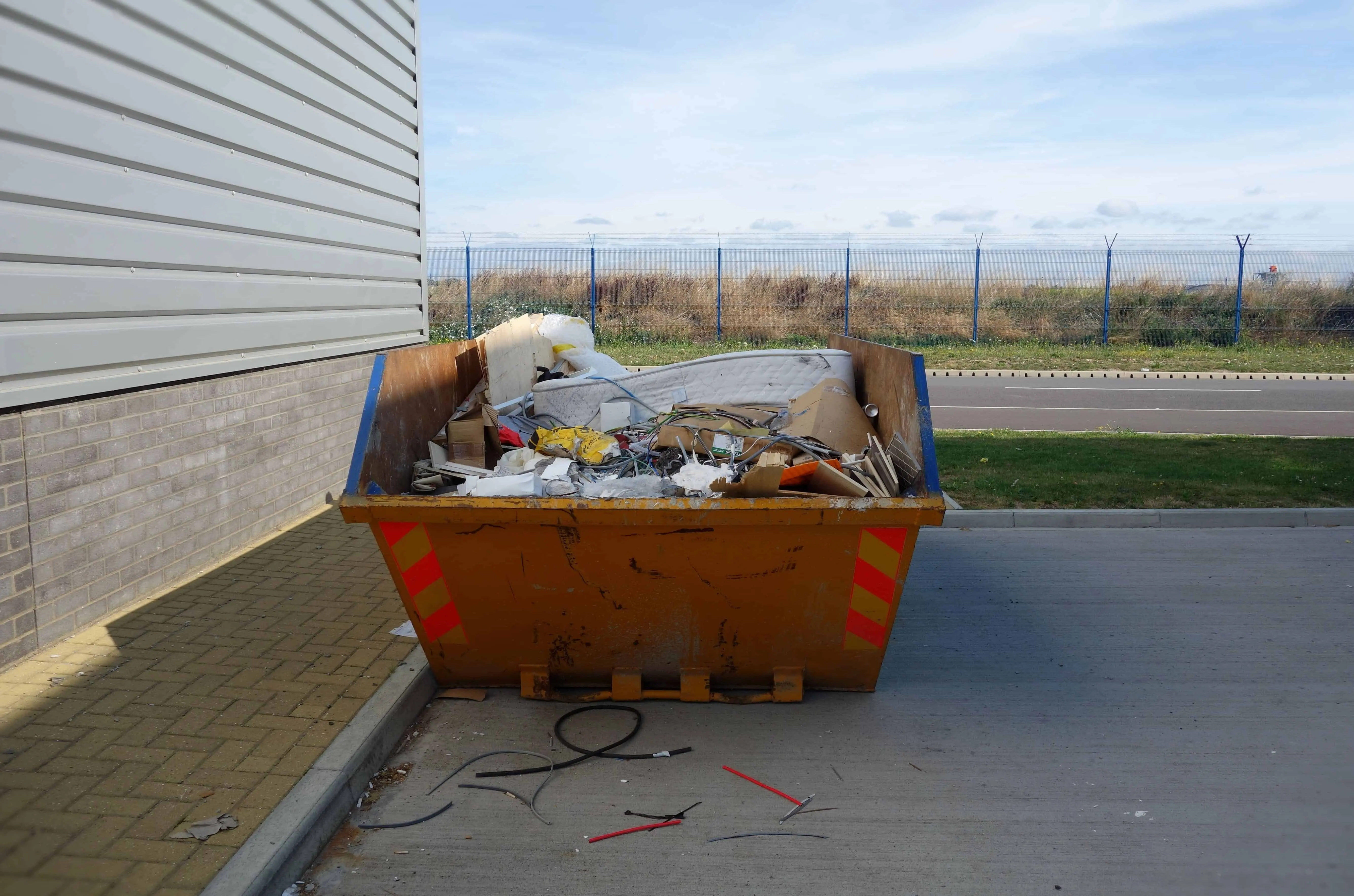 Skip full of office furniture and rubbish during renovation