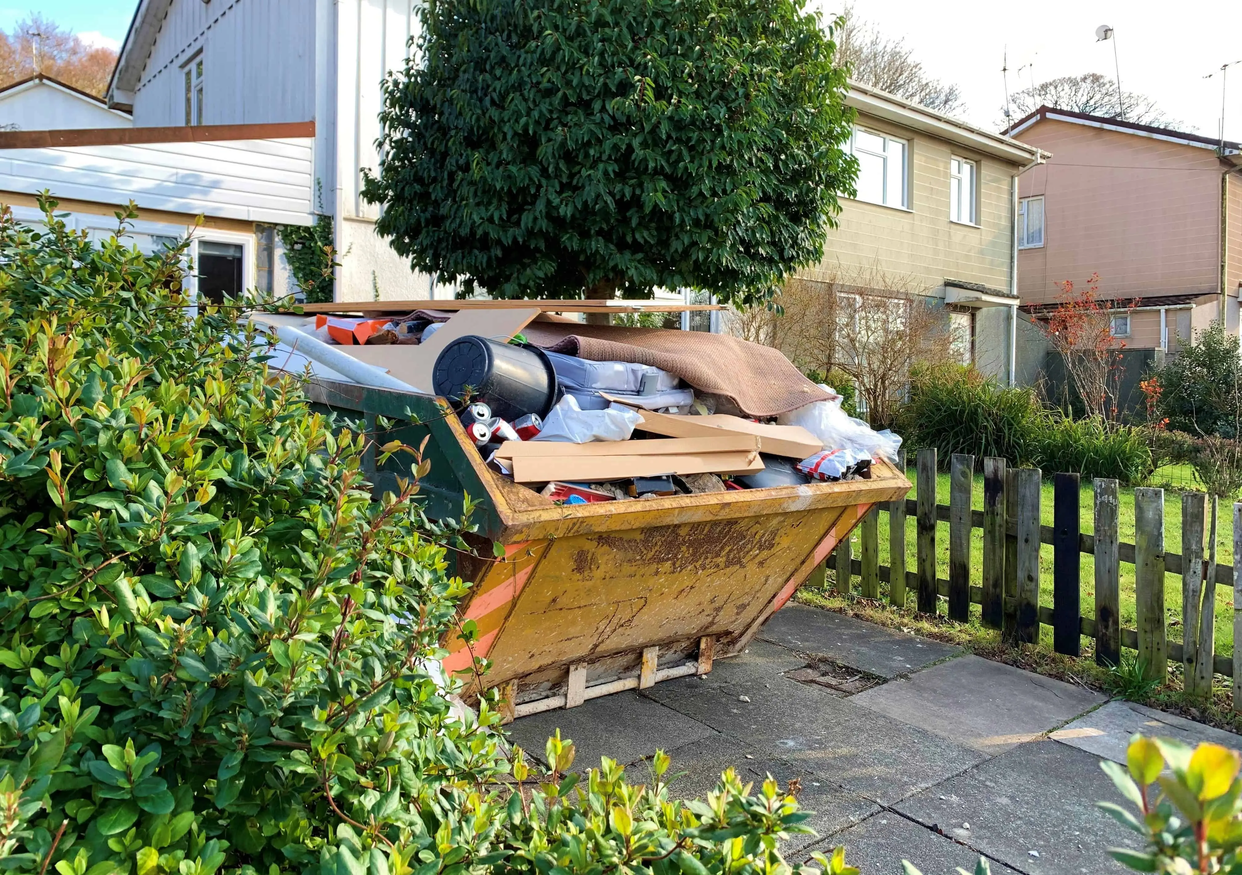 Full industrial rubbish skip with blurred surroundings for text%2C suggesting renovation or skip hire